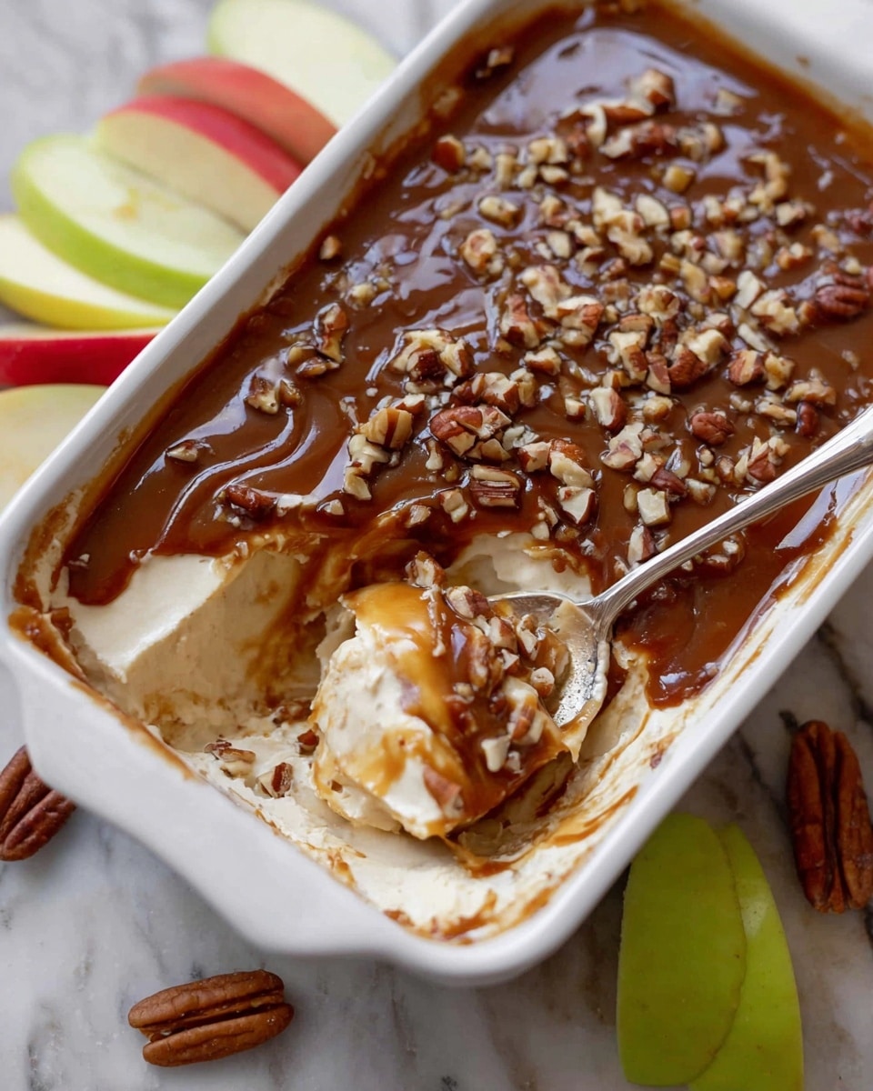 A rectangular white dish filled with a smooth, even layer of dark brown sauce covering the entire surface, with a glossy texture and subtle variations in shade that reflect light gently; the dish sits on a white marbled textured surface, with a few apples partially visible in the top right corner. Photo taken with an iphone --ar 4:5 --v 7