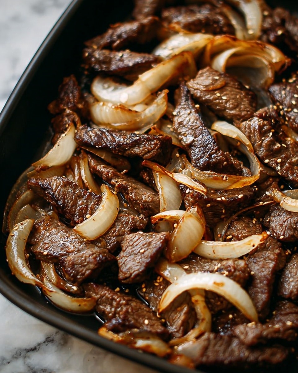 The image shows cooked slices of dark brown beef mixed with golden brown cooked onions, all scattered on a black pan. The beef pieces have a slightly crispy texture with visible grill marks and some sesame seeds sprinkled on top, while the onions are soft with some charred edges and a translucent shine. The overall look is juicy and flavorful with a glossy finish from the cooking oil. Photo taken with an iphone --ar 4:5 --v 7