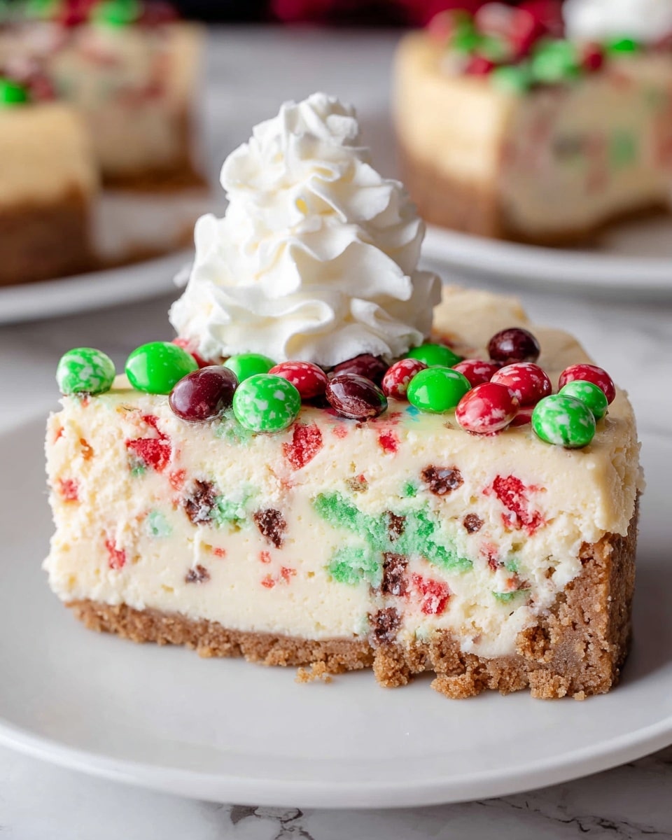 A slice of cheesecake is shown on a white plate, with three clear layers visible. The bottom layer is a brown crumbly crust. The middle layer is thick and creamy with red and green colorful bits mixed inside, giving a speckled look. The top has a smooth light cream layer, scattered with red and green candy-coated chocolates. A big dollop of white whipped cream sits on one side of the slice. The background has a white marbled texture with blurred similar cheesecakes in the distance. photo taken with an iphone --ar 4:5 --v 7