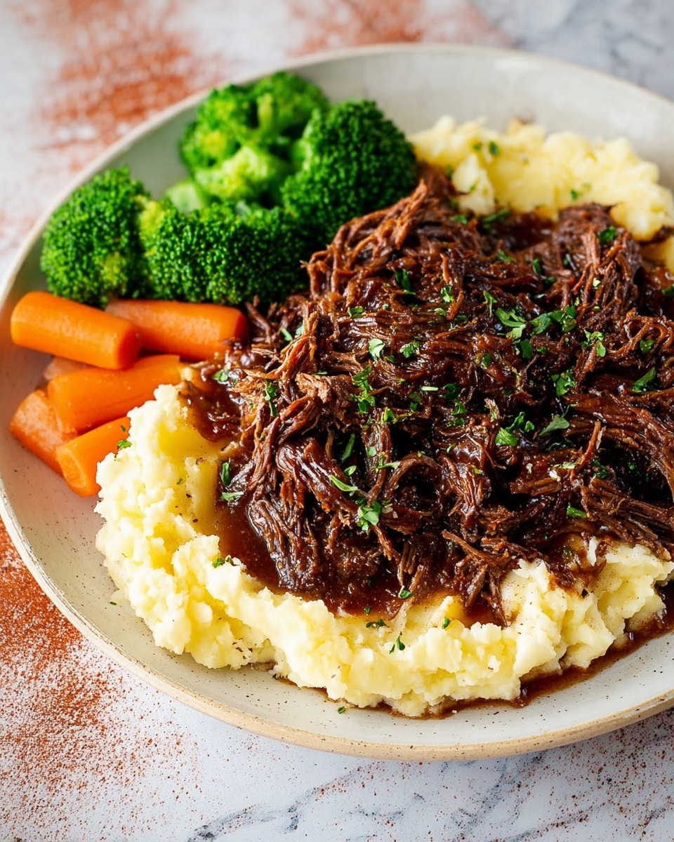 A large white plate holds three layers of food on a white marbled surface. The bottom layer is smooth, creamy mashed potatoes, bright white with a soft texture, spread evenly across the plate base. On top of that is a thick layer of dark brown shredded beef with visible strands and a glossy appearance, mixed with a rich sauce and some sprinkled green herbs for contrast. Next to the beef and mashed potatoes is a side of vibrant green steamed broccoli and slices of soft yellow-orange steamed carrots, adding a fresh, colorful touch to the dish. photo taken with an iphone --ar 4:5 --v 7