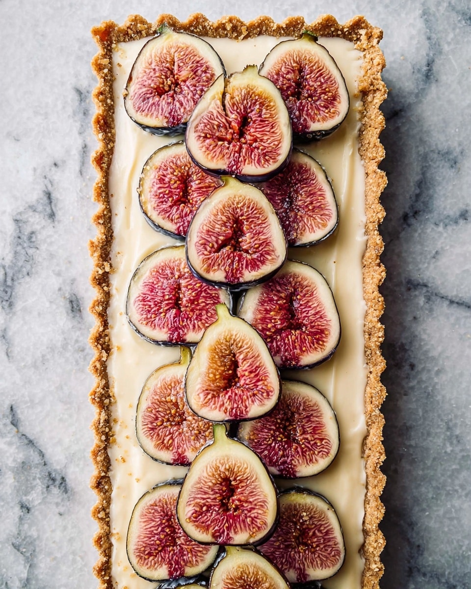 A rectangular tart with a crumbly, golden brown crust forming the base and the edges scalloped, topped with a smooth, creamy off-white filling. On top, there are three neat rows of evenly spaced fresh fig slices, each slice showing a pinkish-red center with tiny seeds and a purple outer edge, creating a colorful contrast against the creamy filling. The tart is placed on a surface with a white marbled texture. photo taken with an iphone --ar 4:5 --v 7