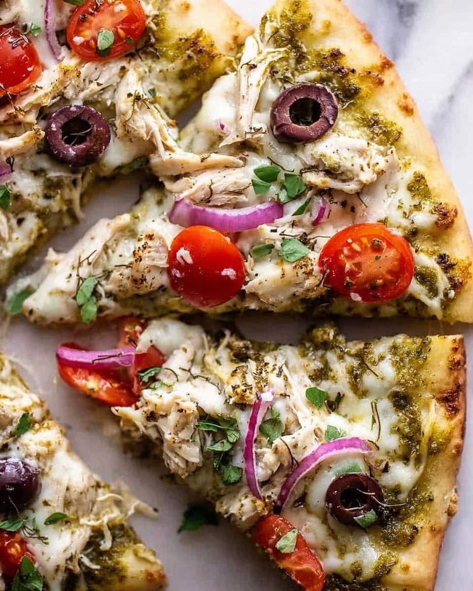A close-up of two pizza slices on a white marbled surface showing a thin crust base with a light green pesto sauce spread evenly as the first layer. Over the sauce is a melted white cheese layer with a smooth, slightly bubbly texture. The toppings include shredded white chicken pieces scattered evenly, slices of red cherry tomatoes, black olives, and thin slices of red onion, all placed on top and garnished with small green herb leaves. The edges of the pizza crust are golden brown and slightly crisp. photo taken with an iphone --ar 4:5 --v 7