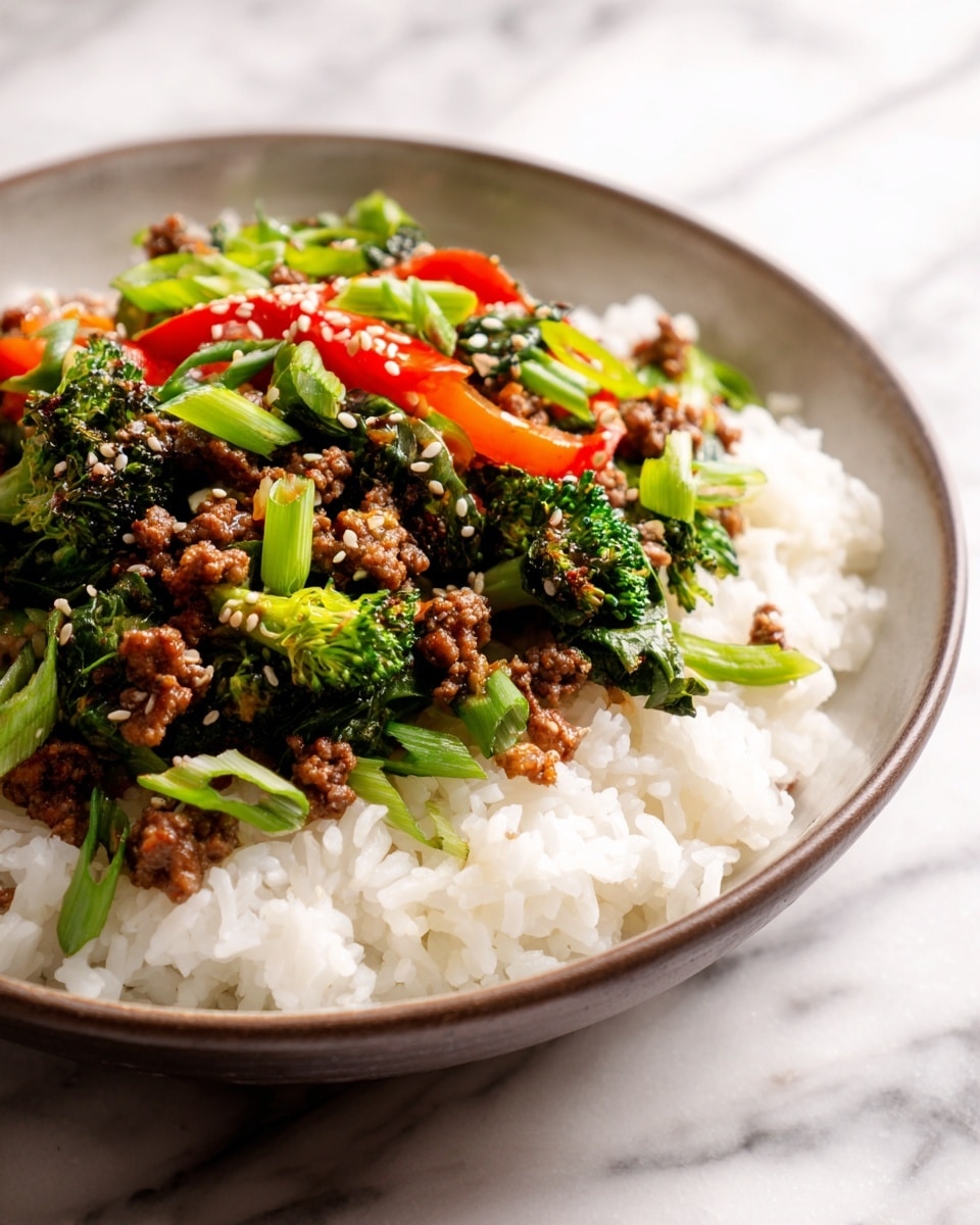 A white bowl filled with a base layer of fluffy white rice topped with a colorful mix of cooked ground meat, bright green broccoli florets, and sliced red bell peppers. The meat looks crumbly and brown, spreading evenly over the rice. Scattered on top are sliced green onions, adding a fresh green accent, with a sprinkling of sesame seeds for texture. The background shows a white marbled surface. Photo taken with an iphone --ar 4:5 --v 7