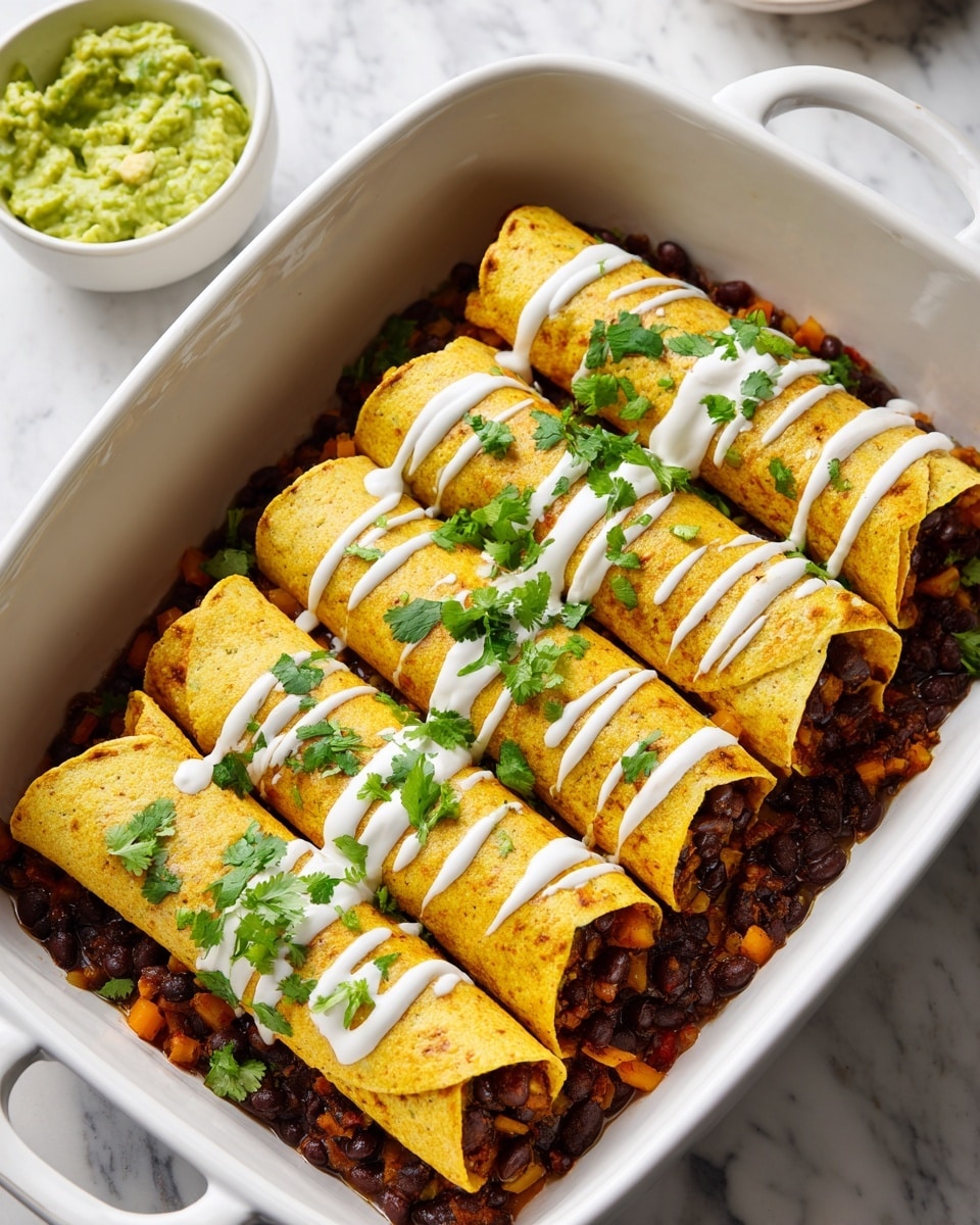 A white rectangular baking dish holds four rolled yellow corn tortillas filled with a dark brown and orange vegetable mix, placed side by side. The dish is layered at the bottom with whole black beans scattered evenly, some mixed with small orange vegetable pieces. Each rolled tortilla is topped with thin white drizzles of sour cream and bright green fresh cilantro leaves spread across the rolls. The dish rests on a white marbled surface, with a white bowl containing light green guacamole in the background. photo taken with an iphone --ar 4:5 --v 7